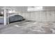 Underground parking garage with concrete walls, numbered parking spots, and a car covered with a tarp at 6435 S Dayton St # 103, Englewood, CO 80111