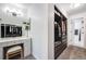 A walk-in closet with dressing table and a lighted mirror with white cabinets and lots of storage at 6435 S Dayton St # 103, Englewood, CO 80111