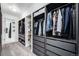 Spacious walk-in closet with custom shelving, drawers, and hanging racks for optimal organization and storage at 6435 S Dayton St # 103, Englewood, CO 80111
