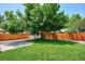 Lovely backyard with green grass, a concrete patio, and a storage shed, perfect for outdoor activities at 1687 S Field Ct, Lakewood, CO 80232