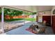 Backyard patio features mature trees, landscaping, and a peaceful area to relax at 1687 S Field Ct, Lakewood, CO 80232