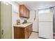 Basement kitchenette with a refrigerator and upper and lower cabinets at 1687 S Field Ct, Lakewood, CO 80232