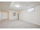 Spacious basement featuring carpet floors, white walls, and a garden window for natural light at 1687 S Field Ct, Lakewood, CO 80232