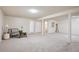 The spacious basement features neutral carpet, white walls, and access to the bathroom at 1687 S Field Ct, Lakewood, CO 80232