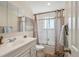 Well-lit bathroom with a vanity, a mirrored medicine cabinet, and a shower with modern curtain at 1687 S Field Ct, Lakewood, CO 80232