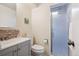 Updated bathroom features a shower and gray vanity for a modern look at 1687 S Field Ct, Lakewood, CO 80232