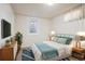 This bedroom features a blue and white comforter and a view of the outside at 1687 S Field Ct, Lakewood, CO 80232