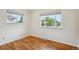 Bedroom with hardwood floors and two windows offering plenty of natural light at 1687 S Field Ct, Lakewood, CO 80232