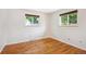 Empty bedroom featuring hardwood floors, and large windows offering nice views of the neighborhood at 1687 S Field Ct, Lakewood, CO 80232
