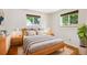 A cozy bedroom with hardwood floors, neutral tones, and natural light coming through the windows at 1687 S Field Ct, Lakewood, CO 80232