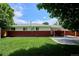 Exterior view of the home with a well-manicured lawn and a covered porch for relaxing at 1687 S Field Ct, Lakewood, CO 80232