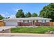 Charming single-story home with a well-manicured lawn, brick accents, and mature trees at 1687 S Field Ct, Lakewood, CO 80232