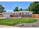 Charming single-story home with a well-manicured lawn, brick accents, and mature trees at 1687 S Field Ct, Lakewood, CO 80232