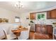 Eat-in kitchen featuring wood cabinets, white countertops and a dining table at 1687 S Field Ct, Lakewood, CO 80232