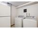 Laundry room with a white washer and dryer, utility sink, and linoleum floors at 1687 S Field Ct, Lakewood, CO 80232