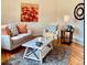 Bright living room features a cozy couch, chair, stylish rug, and decor at 1687 S Field Ct, Lakewood, CO 80232