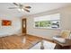 Living room features hardwood floors, a ceiling fan, and a view to the front yard at 1687 S Field Ct, Lakewood, CO 80232