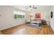 Bright living room featuring hardwood floors, a large window, and neutral decor at 1687 S Field Ct, Lakewood, CO 80232