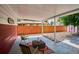 Relax on this covered patio with seating, a rug, and a view of the spacious backyard at 1687 S Field Ct, Lakewood, CO 80232