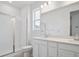 Bright bathroom with double vanity, quartz countertop, and glass-enclosed shower at 45928 Gentry Ave, Bennett, CO 80102