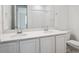 Bathroom with double sinks, modern fixtures, and plenty of counter space at 45928 Gentry Ave, Bennett, CO 80102