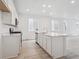 Modern kitchen with white cabinets, stainless steel appliances, and a functional center island at 45928 Gentry Ave, Bennett, CO 80102
