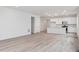 Large living space with modern kitchen and wood-look flooring, perfect for entertaining at 45928 Gentry Ave, Bennett, CO 80102