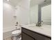 Bathroom features neutral colors, tub and shower combination with white subway tile and modern vanity at 4586 Windmill Dr, Brighton, CO 80601