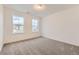 An ample bedroom with two windows providing plenty of natural light and plush carpeting at 4586 Windmill Dr, Brighton, CO 80601