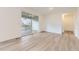 Open room with a large glass sliding door to a backyard deck or patio and neutral wall color at 4586 Windmill Dr, Brighton, CO 80601
