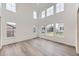 Bright living room boasts soaring ceilings and an abundance of natural light through large picture windows at 4586 Windmill Dr, Brighton, CO 80601