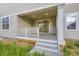 Relaxing covered patio with white railings, sliding glass door, and convenient access to the backyard at 4586 Windmill Dr, Brighton, CO 80601