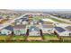 This aerial view showcases the neighborhood and the home's location near a pond at 17801 E 95Th Pl, Commerce City, CO 80022