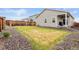 The backyard features dead grass and rock landscaping at 17801 E 95Th Pl, Commerce City, CO 80022