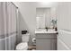 Well lit bathroom with vanity, toilet, tub, and shower with decorative shower curtain at 17801 E 95Th Pl, Commerce City, CO 80022