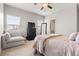 Spacious bedroom with full bed, and couch sitting area at 17801 E 95Th Pl, Commerce City, CO 80022