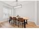 Bright dining room with a modern light fixture and a wooden table with bench seating at 17801 E 95Th Pl, Commerce City, CO 80022