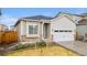 Beautiful single-Gathering home featuring a 2-car garage, stone accents, and a well-manicured lawn at 17801 E 95Th Pl, Commerce City, CO 80022