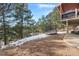 Spacious backyard with a trampoline, patio, and mountain views at 3028 Olympia Cir, Evergreen, CO 80439