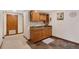 Basement wet bar with wood cabinets and granite countertop at 3028 Olympia Cir, Evergreen, CO 80439