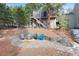 Cozy fire pit area with stone patio and seating at 3028 Olympia Cir, Evergreen, CO 80439