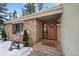 Inviting front entrance with stone accents and wooden door at 3028 Olympia Cir, Evergreen, CO 80439