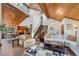 Open concept living room with hardwood floors and a view into the kitchen at 3028 Olympia Cir, Evergreen, CO 80439