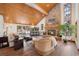 Living room with a stone fireplace, vaulted ceiling, and hardwood floors at 3028 Olympia Cir, Evergreen, CO 80439