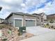 Charming home featuring a stone facade, an attached two car garage and xeriscaping at 3966 Doubletrack Ln, Castle Rock, CO 80108