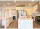 Bright, open kitchen with stainless steel appliances, double islands and white cabinets at 3966 Doubletrack Ln, Castle Rock, CO 80108