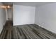 Neutral living room with wood-look flooring and fresh white walls at 26 S Gay Dr, Longmont, CO 80501