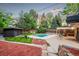 Spacious backyard featuring a swimming pool, lush lawn, and patio with outdoor seating at 1440 S Dahlia St, Denver, CO 80222