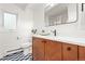 Stylish bathroom with modern vanity, large mirror, and window for plenty of light at 1440 S Dahlia St, Denver, CO 80222
