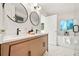 Bright bathroom with dual sink vanity, modern fixtures and a soaking tub at 1440 S Dahlia St, Denver, CO 80222